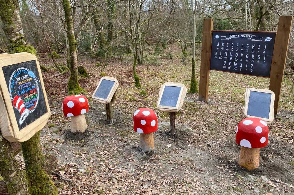 mushroom seats with chalkboard on a trail