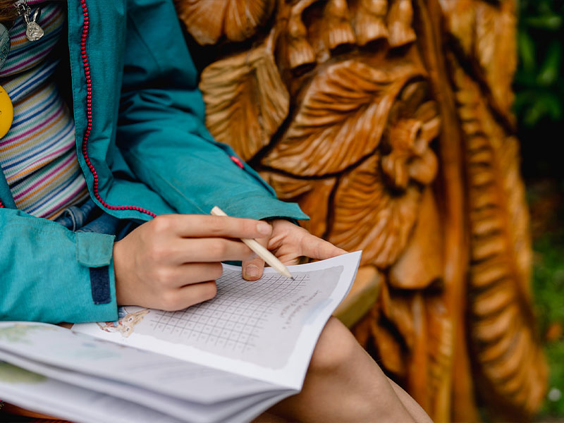 Child completing the Beatrix Potter Garden Trail Activity Book.