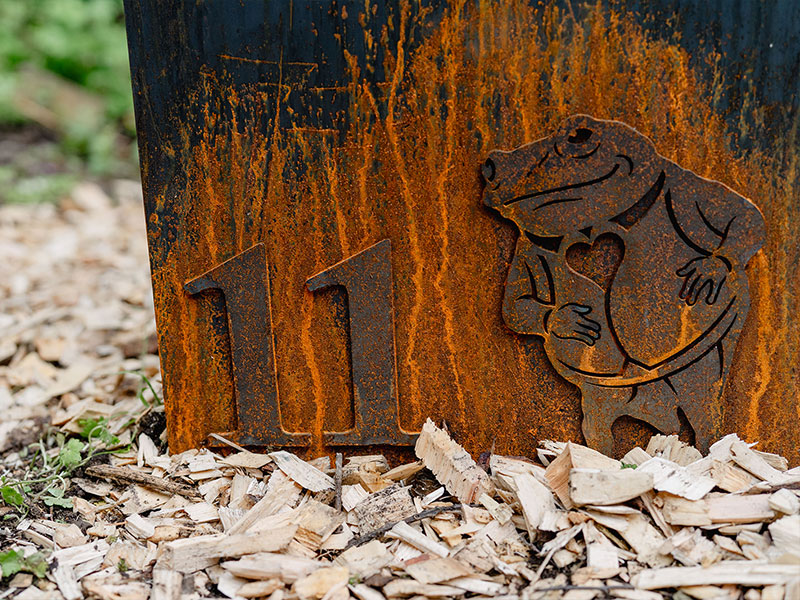 Corten steel trail marker featuring a Beatrix Potter character.