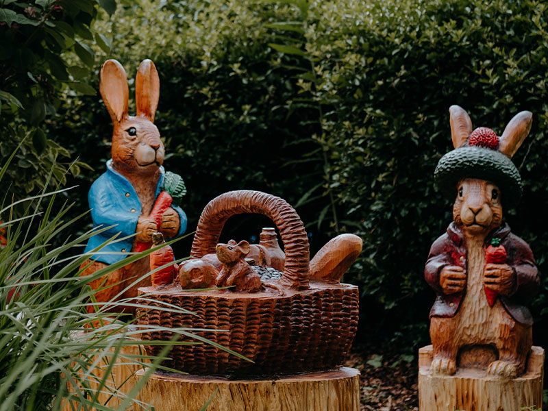Peter Rabbit characters enjoying a garden picnic.