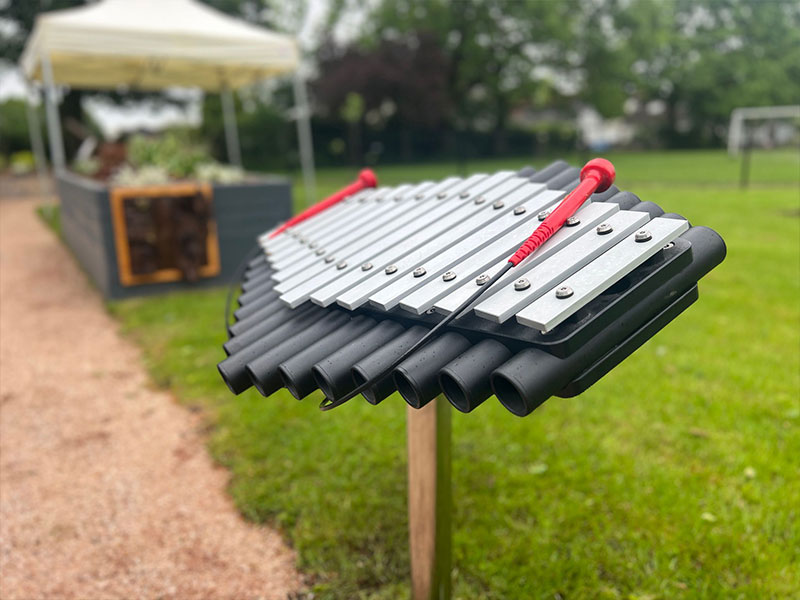 Outdoor musical instrument creating an interactive sound experience in a sensory garden